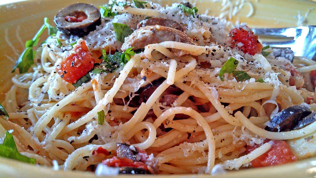 Pasta Puttanesca is classic Italian robust pasta dish traditionally with anchovies, black olives, capers. A quick and easy meal with intense Italian flavor! | TheMountainKitchen.com