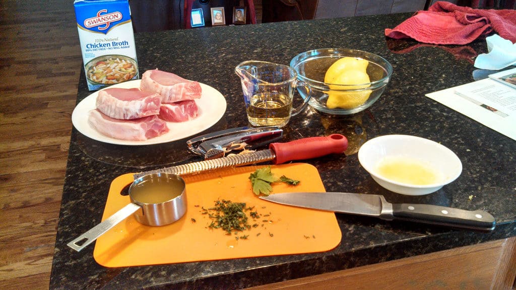 Sexy Pork Chops are smothered in a wonderful zesty sauce made of white wine, chicken broth, and garlic then finished off with lemon and fresh herbs. | TheMountainKitchen.com