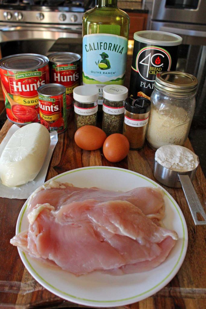 I practically drool just thinking about this delicious chicken parmesan. Lightly browned melted gooey cheese and fresh basil top these crispy breaded chicken breasts lying on a bed of tomato sauce with a side order of spaghetti. This is food that comforts the soul! | TheMountainKitchen.com