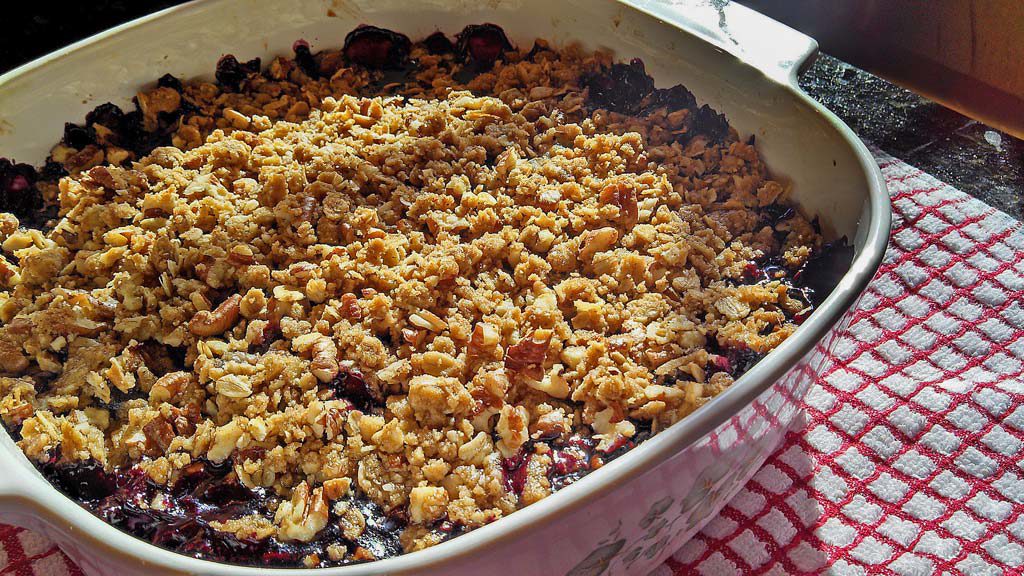 Celebrate your favorite summer berry with this blueberry crisp. Warm tart blueberries topped with a pecan cinnamon and oat topping. | TheMountainKitchen.com