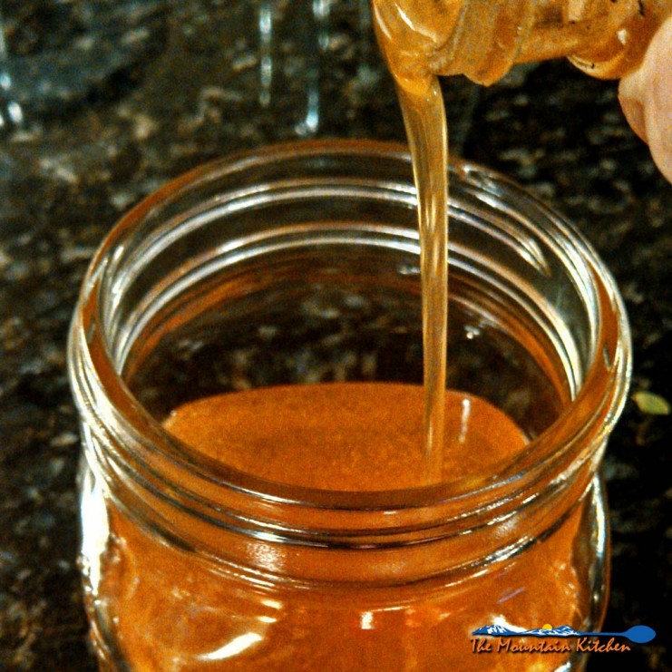honey pouring in jar