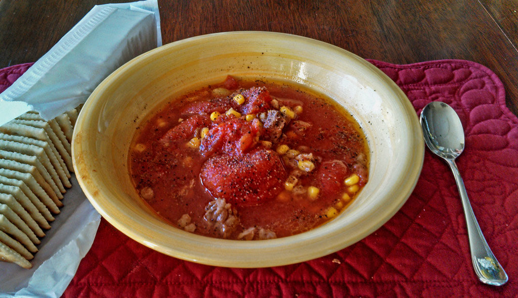 This comforting and hearty crock-pot vegetable beef soup has chunks of beef, stewed tomatoes, corn and lima beans. A delicious soup with very little effort! | TheMountainKitchen.com
