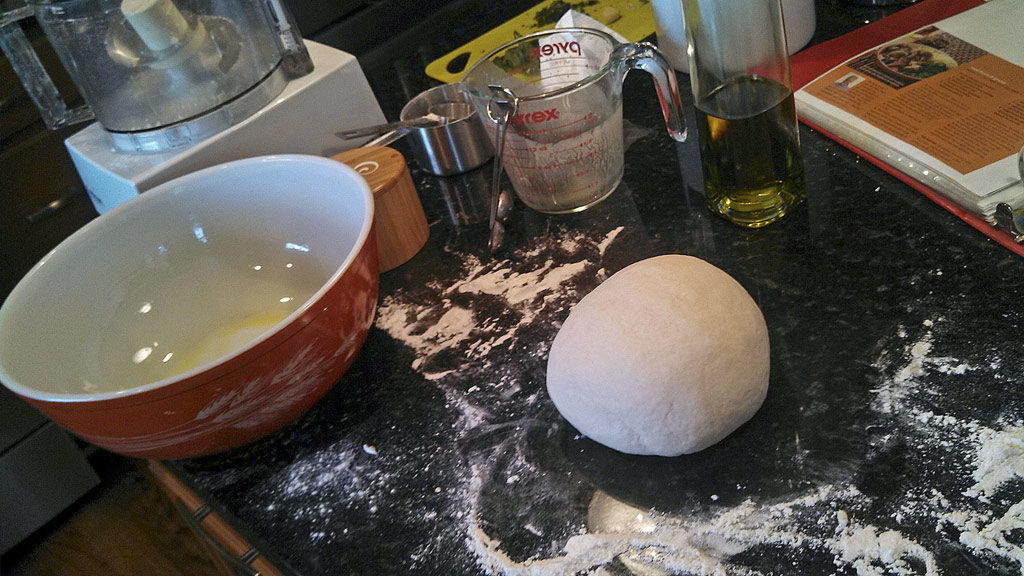 ball of dough on messy kitchen counter