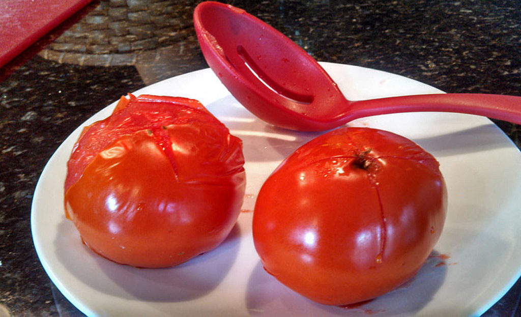 Easy to follow instructions on how to peel and core tomatoes. You can process 3-4 tomatoes at a time using the boiling water method. | TheMountainKitchen.com