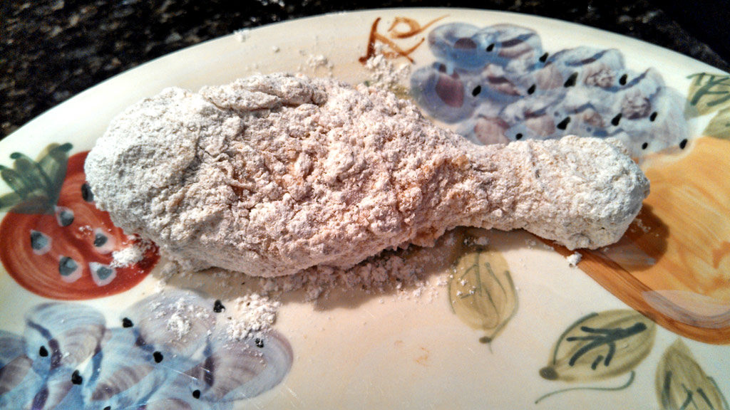 battered chicken leg ready to fry