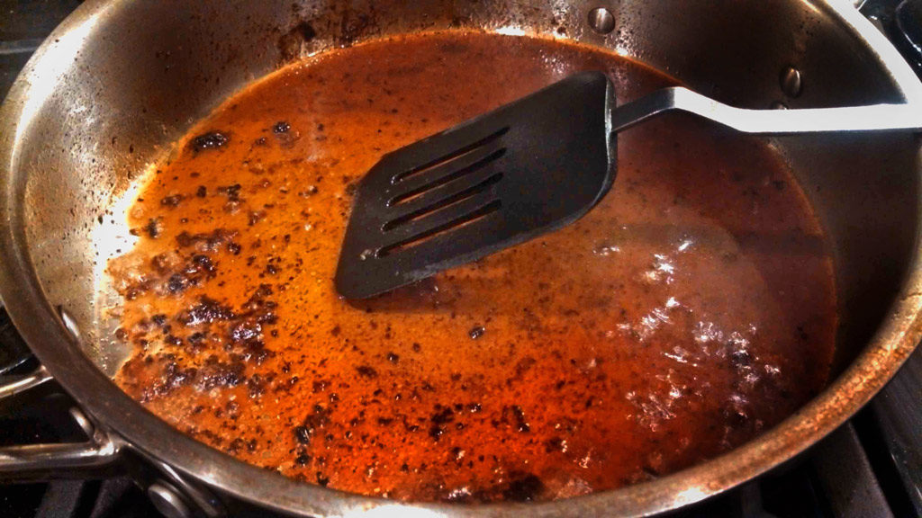 scraping brown bits with spatula