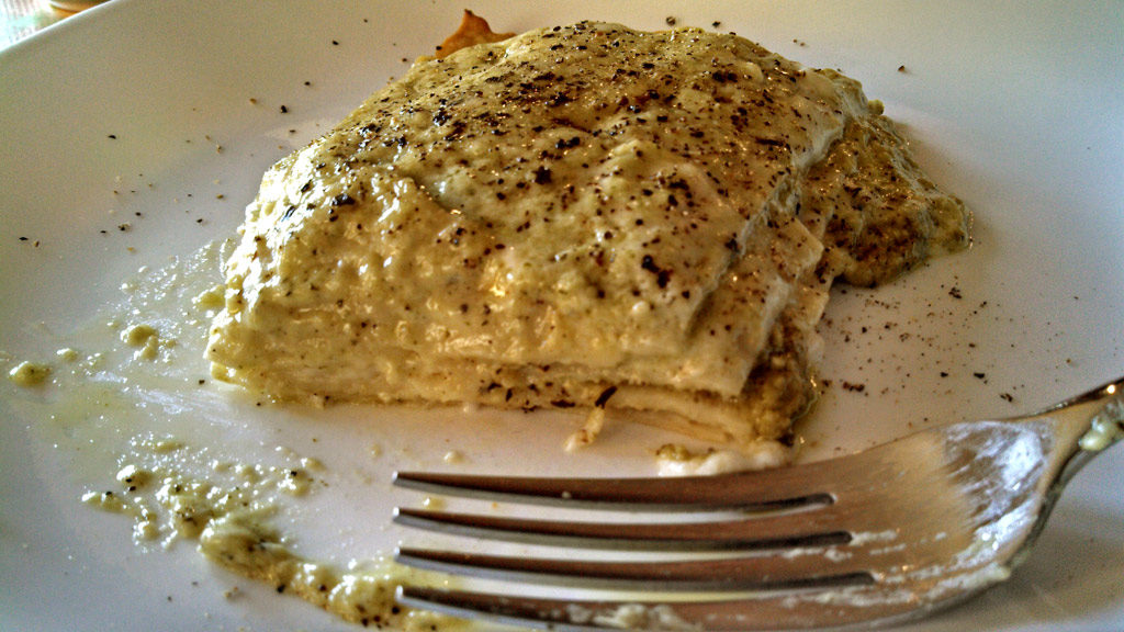 pesto lasagna on plate with fork