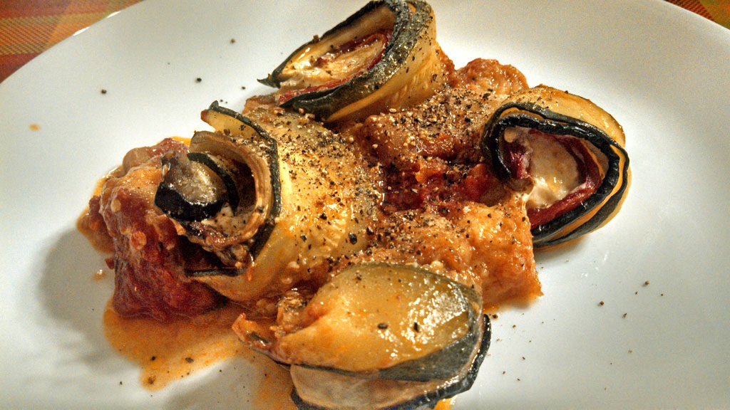 Ratatouille spirals are made of sliced eggplant, zucchini, roasted red peppers, creamy mozzarella cheese, and anchovies, rolled and baked in tomato sauce. | TheMountainKitchen.com