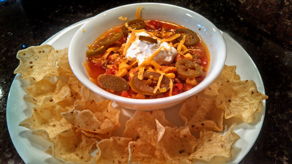 This easy to follow crock-pot Taco Soup is made of ground beef, seasoned with taco spices and cooked with beans and corn in a rich tomato sauce. Yumminess! | TheMountainKitchen.com