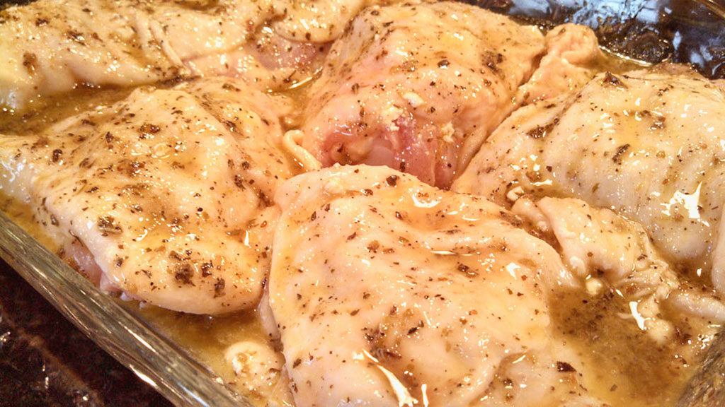 Taste the Mediterranean with these Greek-Style Chicken Thighs stuffed with tangy goat cheese and marinated in a bold and zesty Greek Dressing. | TheMountainKitchen.com