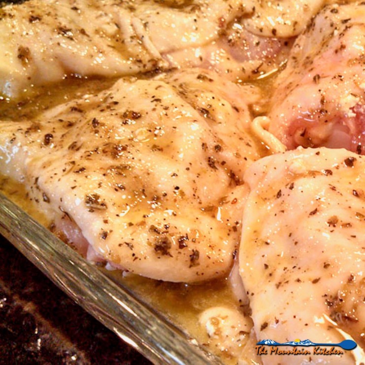 Taste the Mediterranean with these Greek-Style Chicken Thighs stuffed with tangy goat cheese and marinated in a bold and zesty Greek Dressing. | TheMountainKitchen.com