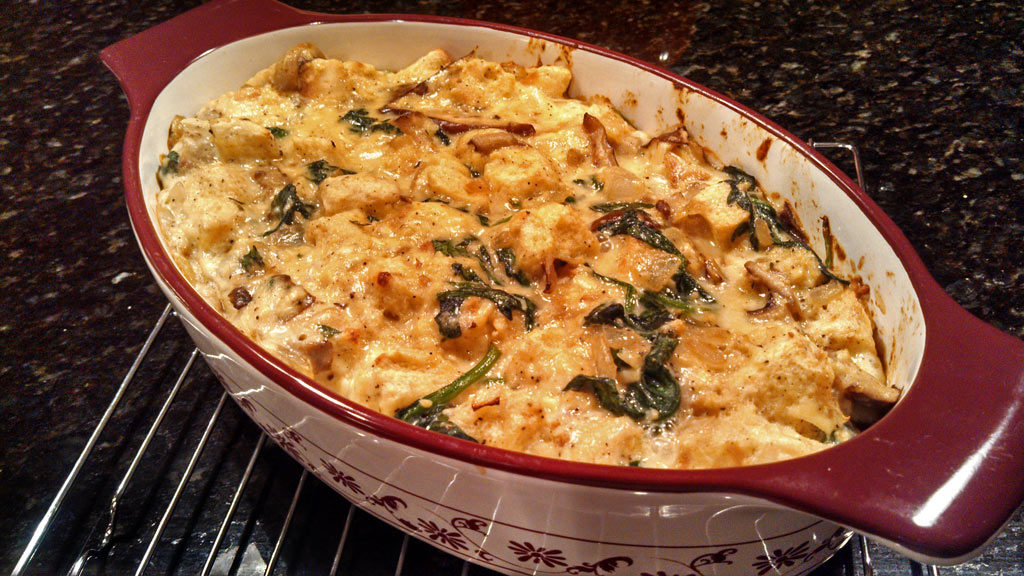 Mushroom spinach strata is a savory bread pudding made of bread, eggs, cheese mushrooms and spinach made with Gouda and Gruyere cheeses. Brunch or dinner! | TheMountainKitchen.com