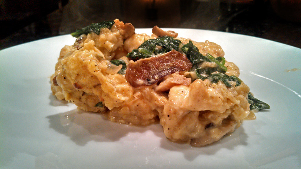 Mushroom spinach strata is a savory bread pudding made of bread, eggs, cheese mushrooms and spinach made with Gouda and Gruyere cheeses. Brunch or dinner! | TheMountainKitchen.com