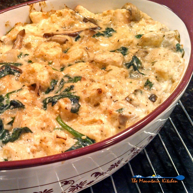 Mushroom spinach strata is a savory bread pudding made of bread, eggs, cheese mushrooms and spinach made with Gouda and Gruyere cheeses. Brunch or dinner! | TheMountainKitchen.com