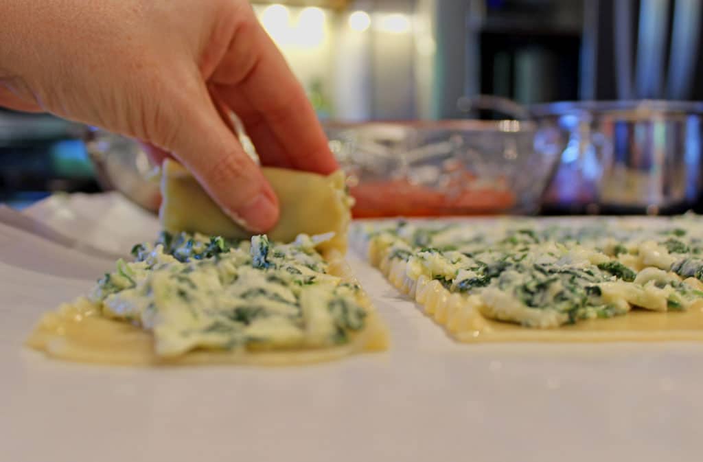 rolling the lasagna noodle around the filling