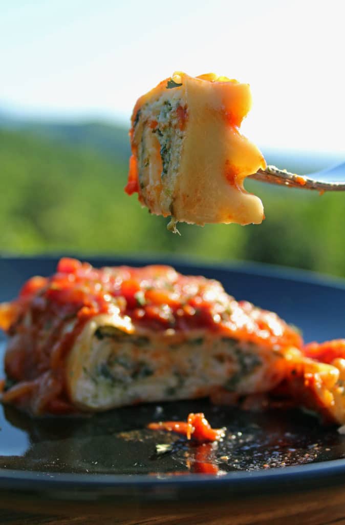 fork holding spinach lasagna roll