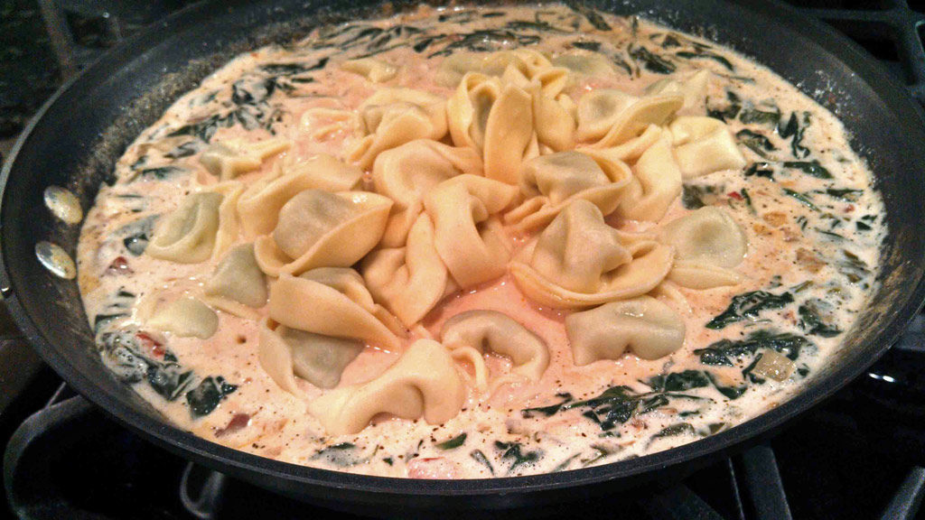 Tortelloni added to the skillet