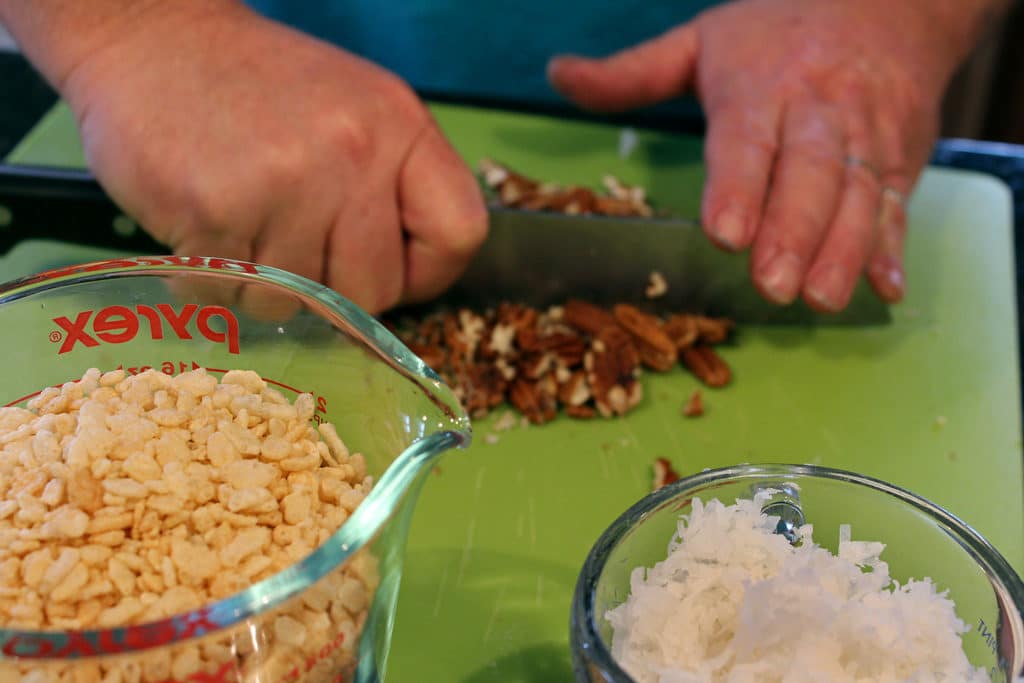 chopping pecans for date nut balls
