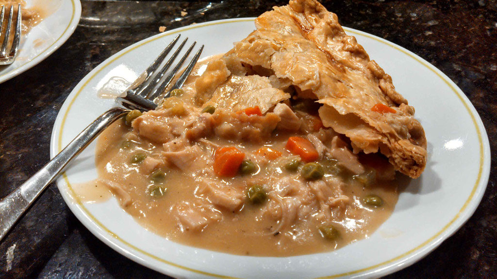 Classic chicken pot pie slopped on plate