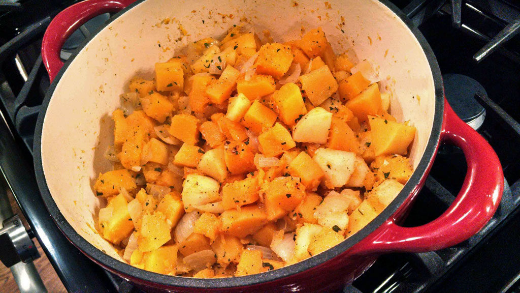 chopped butternut squash onions and apples in pot