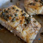 pan seared halibut with caper butter sauce in skillet