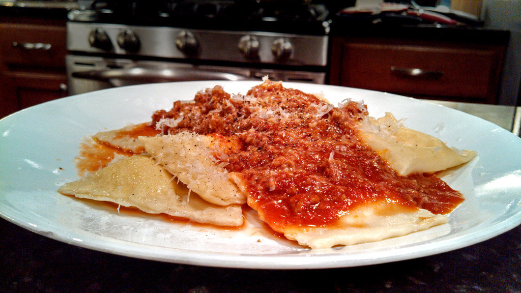 homemade ravioli on plate with sauce