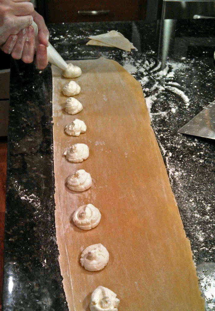piping cheese onto pasta sheet