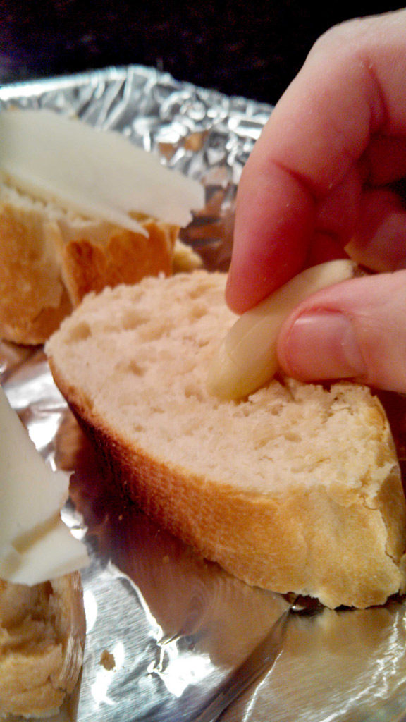 rubbing garlic onto bread