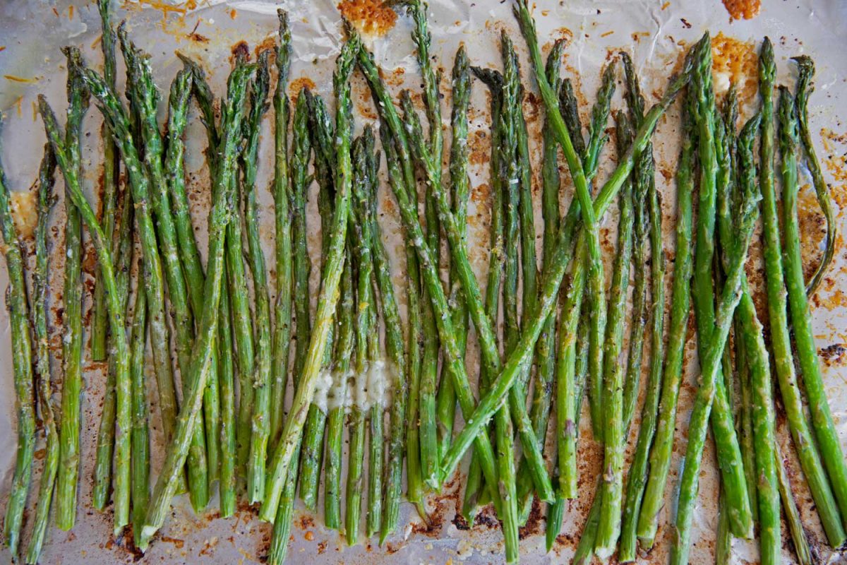 perfectly roasted asparagus with golden parmesan on a sheet pan