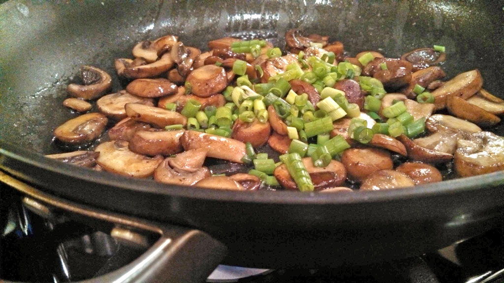 mushrooms and scallions in skillet