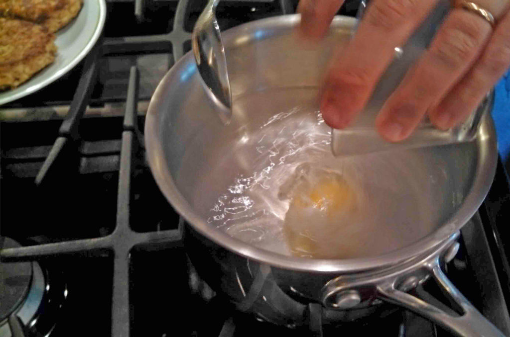 dropping egg into boiling water