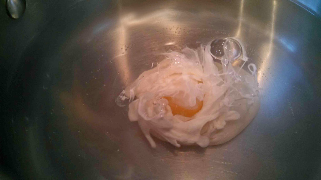 egg poaching in hot water
