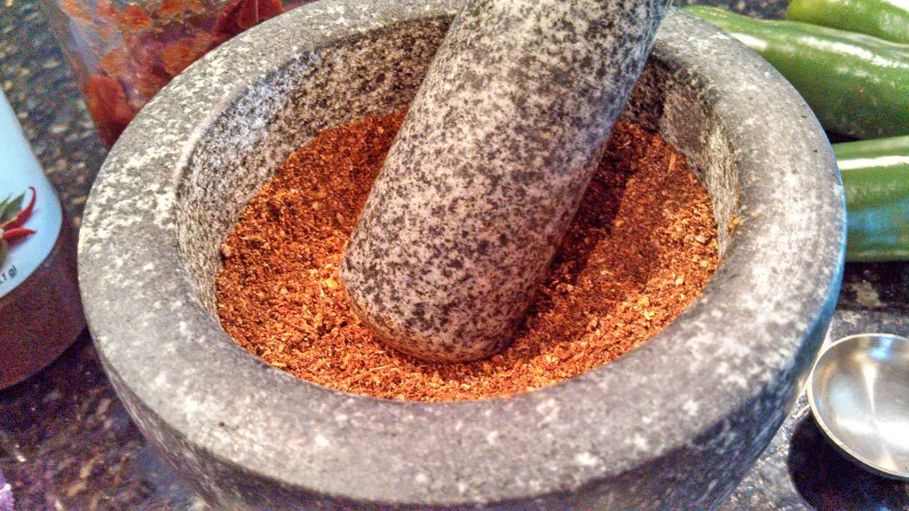 spices ground inside mortar with pestle
