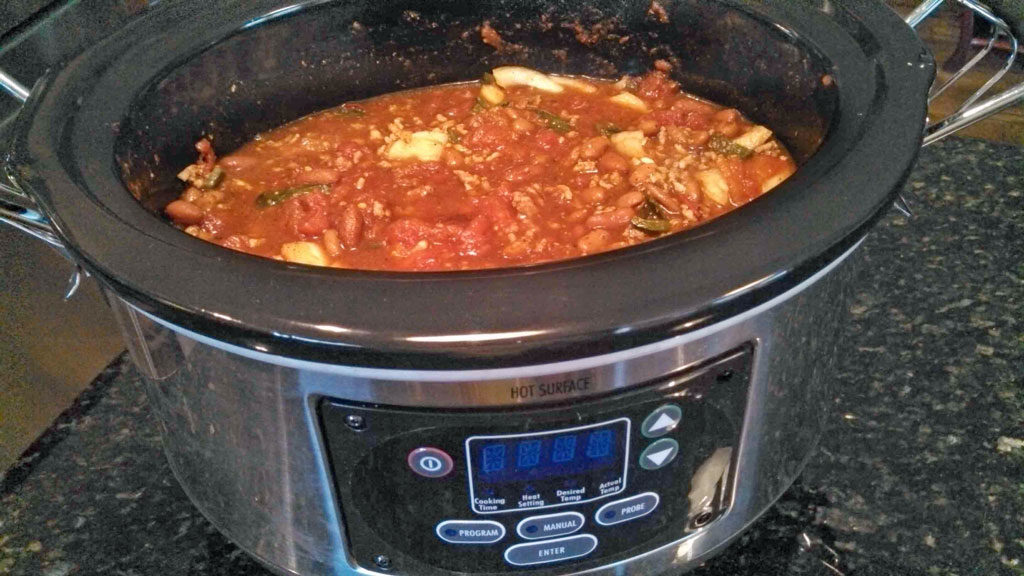crock-pot full of spicy chili ready to eat