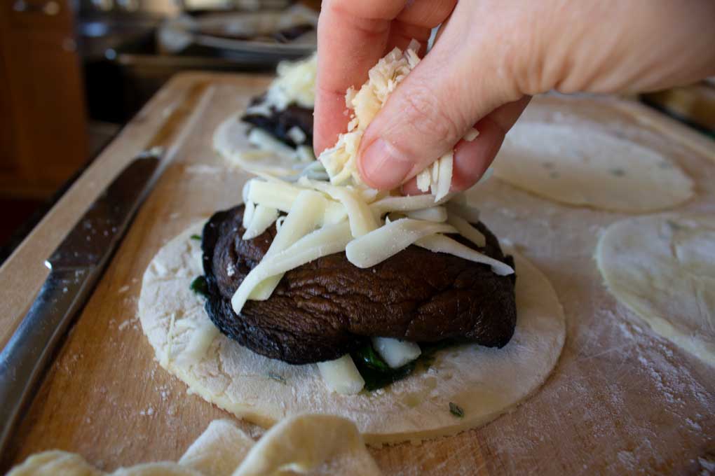 adding cheese on top of mushroom