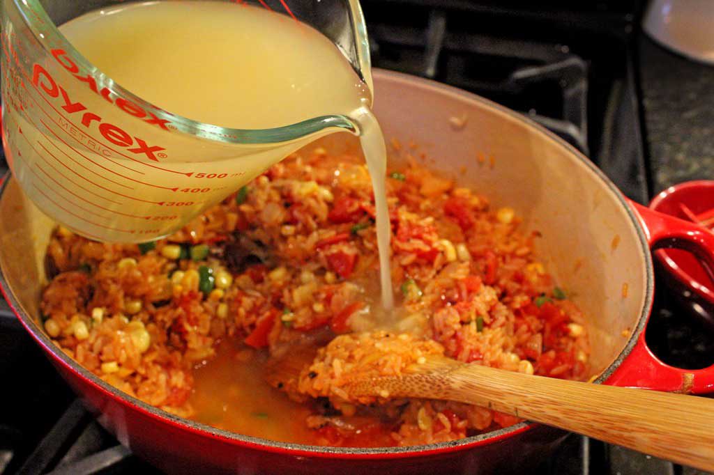 pouring broth into rice