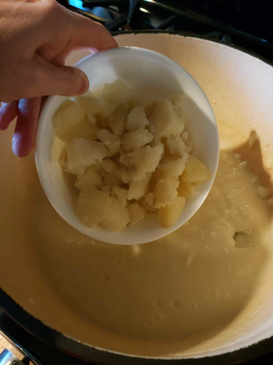 transferring potatoes back into the soup