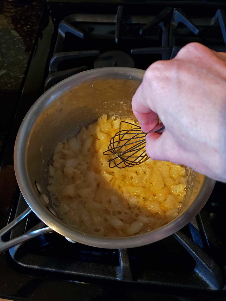 stirring onions in a pot