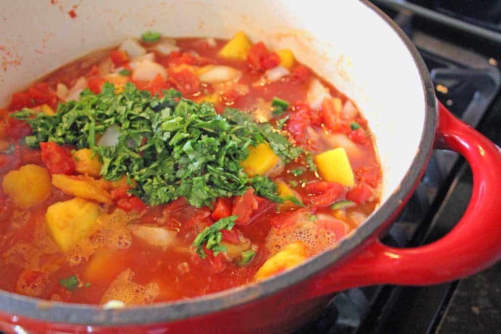 cilantro added to pot of salsa