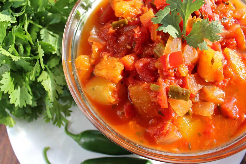 Mango Salsa a flavorful salsa loaded with chunks of fresh mango, tomatoes, onions and jalapenos with Mexican seasonings. Serve warm, over chicken or fish! | TheMountainKitchen.com