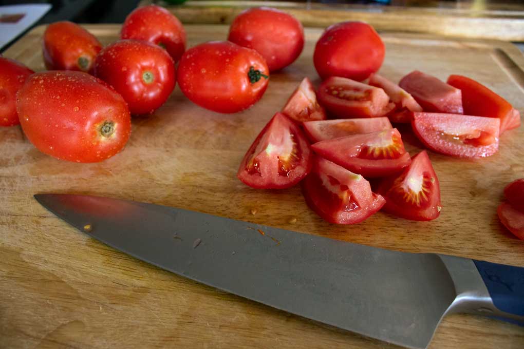 chopped tomatoes on cutting board