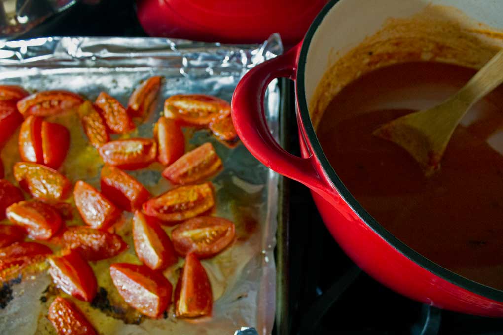 sheet pan of tomatoes and pot of soup
