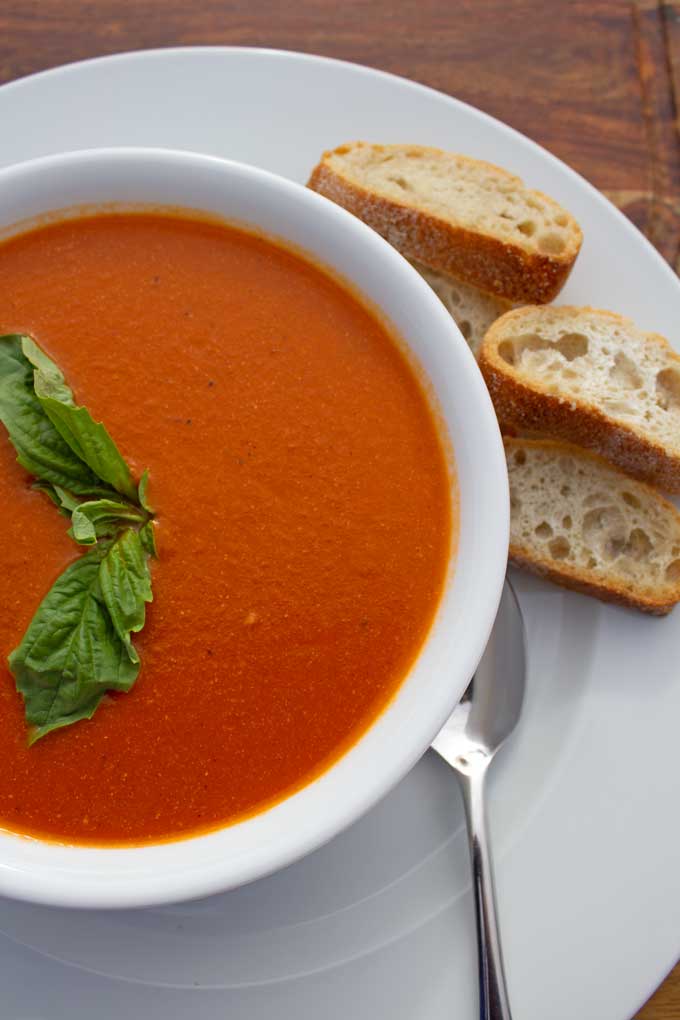 bowl of roasted tomato soup with bread