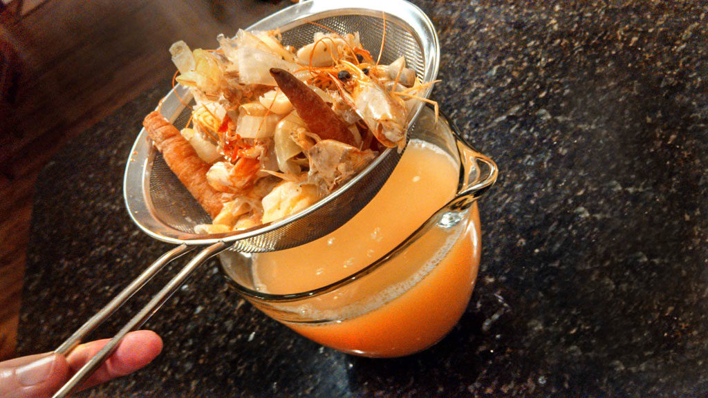 draining the stock through a sieve
