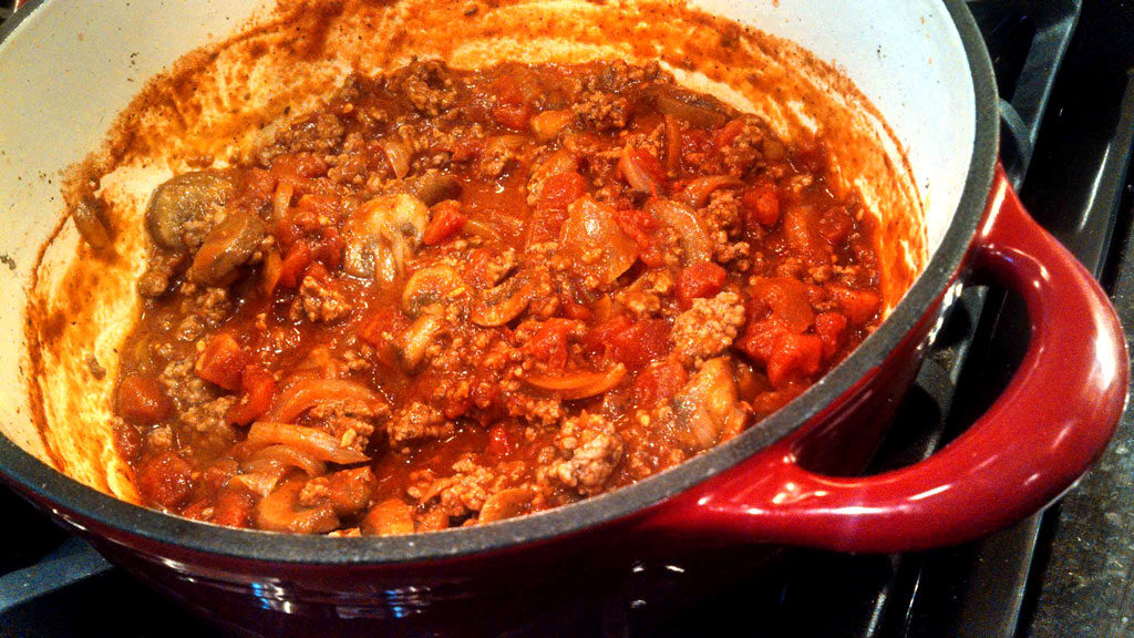 This thick chunky bolognese is loaded with ground beef, tomatoes and onions. It only takes 1 hour, which means it makes a quick and easy weeknight meal! | TheMountainKitchen.com