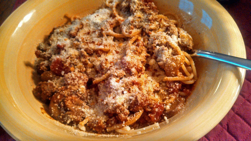 This thick chunky bolognese is loaded with ground beef, tomatoes and onions. It only takes 1 hour, which means it makes a quick and easy weeknight meal! | TheMountainKitchen.com