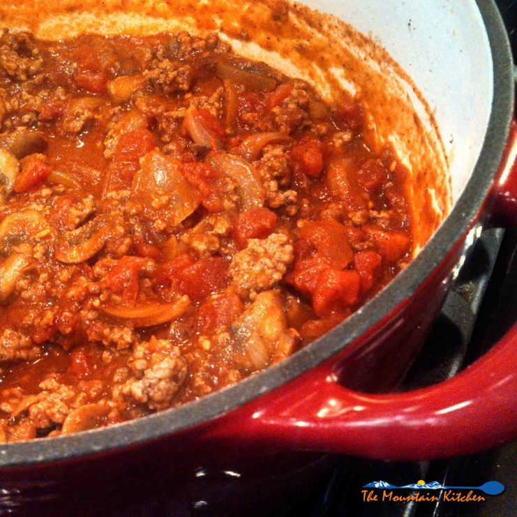 This thick chunky bolognese is loaded with ground beef, tomatoes and onions. It only takes 1 hour, which means it makes a quick and easy weeknight meal! | TheMountainKitchen.com