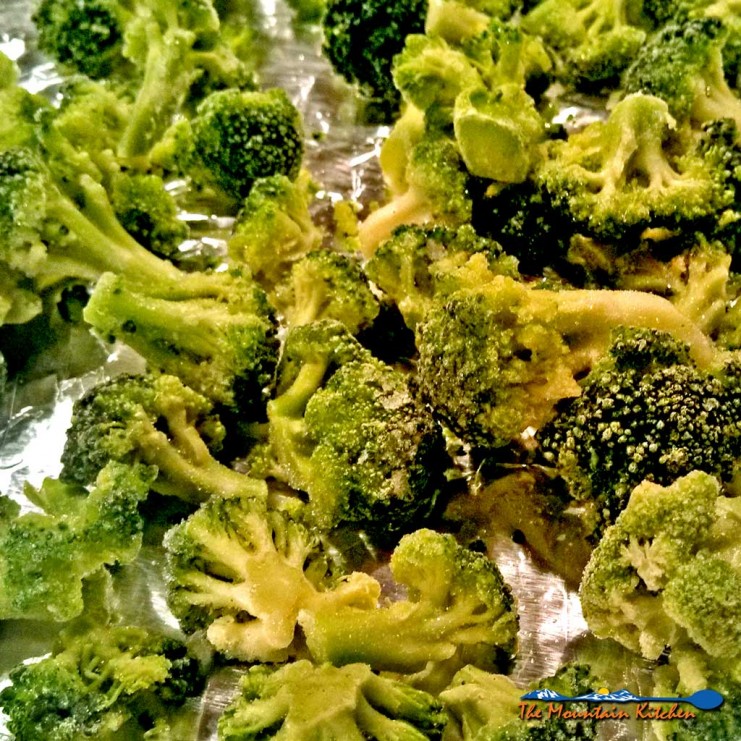 This delicious roasted broccoli is drizzled with olive oil, salt and pepper and then sprinkled with fresh grated parmesan cheese, oven roasted until tender. | TheMountainKitchen.com