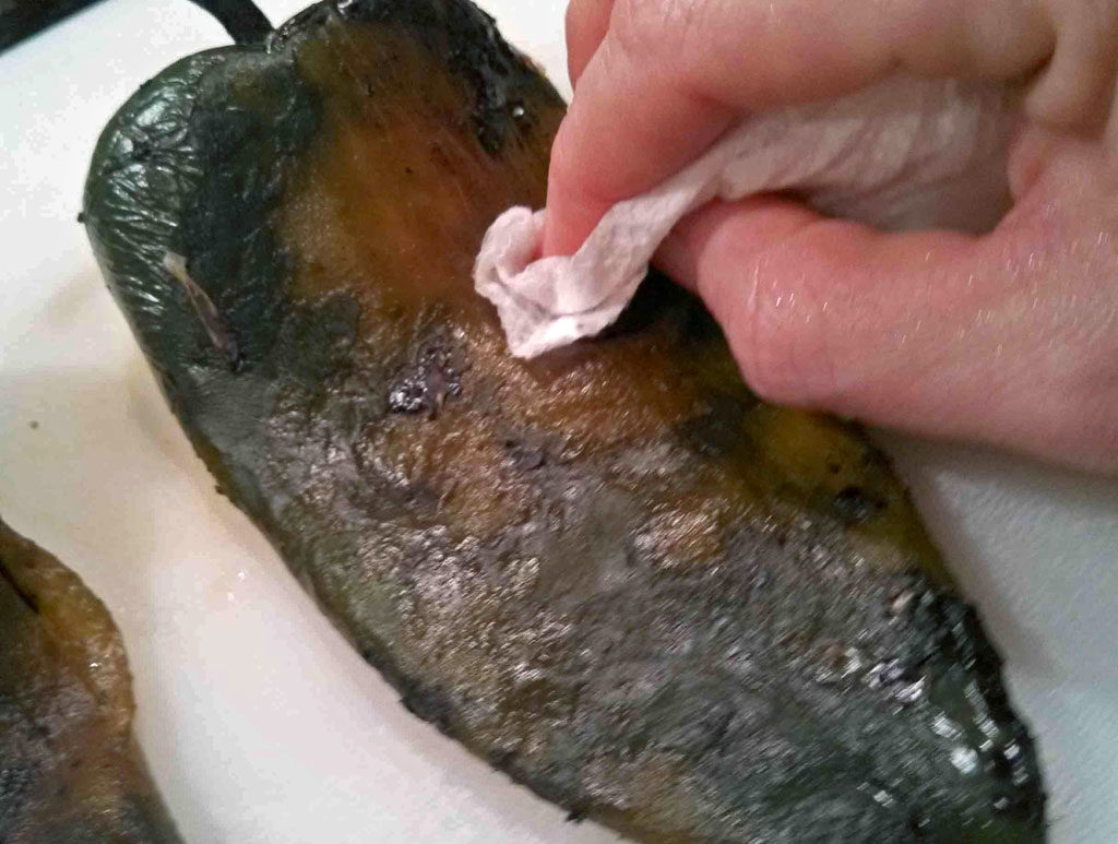 wiping poblano with paper towel