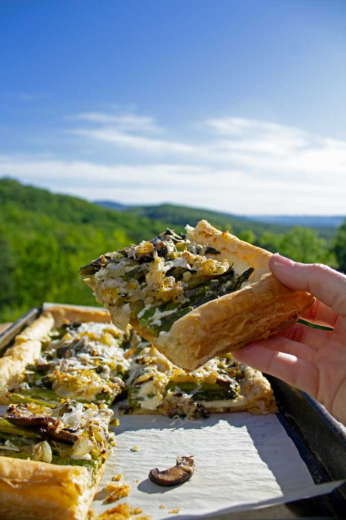 picking up slice of tart with mountain view
